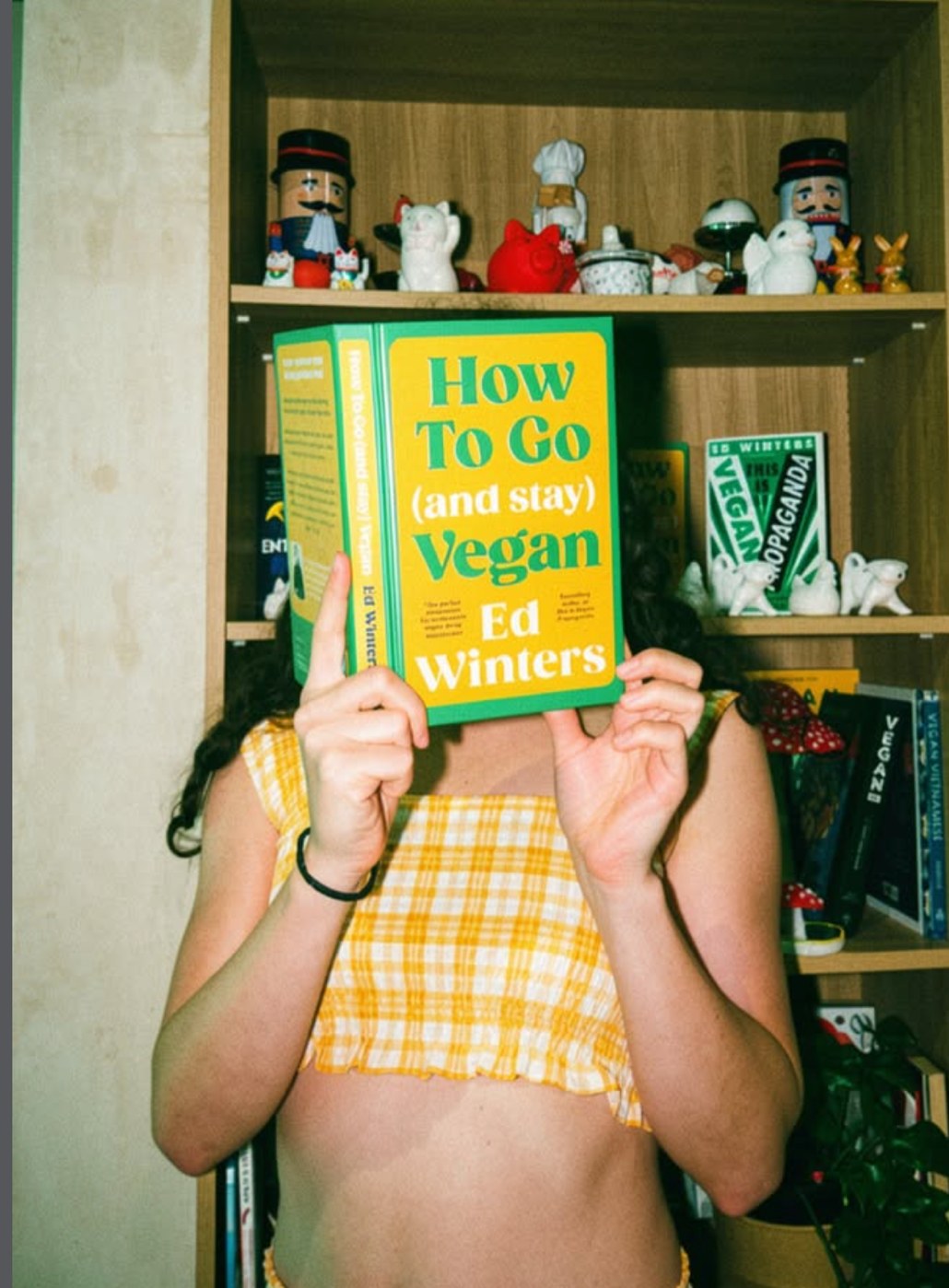 Guest holding ‘How To Go (and stay) Vegan’ by Ed Winters at Plantastic Kitchen